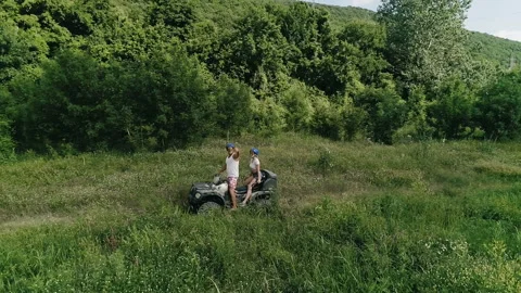 ATVs.Happy couple on vacation.Driving Quad Bikes. Stock Footage 121740341
