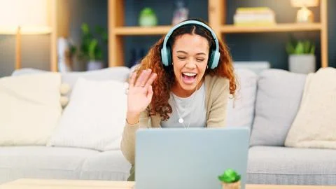 Au pair using laptop and headphones for video call to connect and communicate Fotos Stock