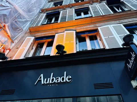 Aubade store front with classic shutters and tall windows on a Paris France.. Foto stock