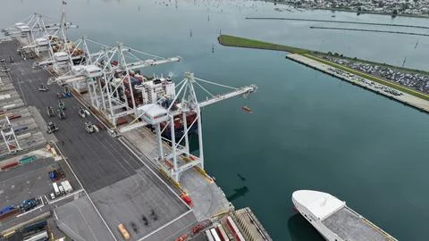 Auckland cargo terminal unloading container ship at port Stock Photos