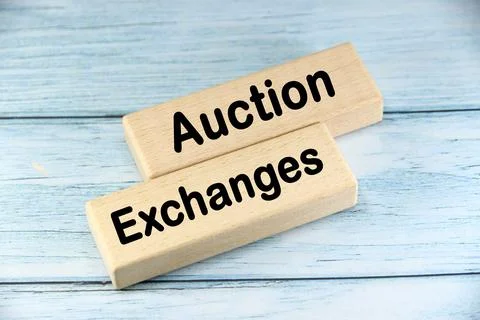 Auction Exchanges wording  or text on wood block with blue background.Copy .. Stock Photos