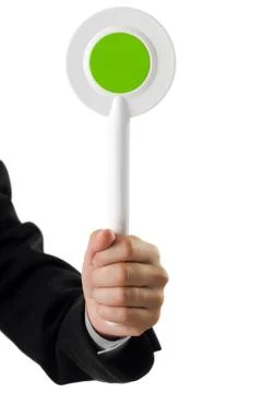 Auction paddle or voting card in hand Stock-Fotos
