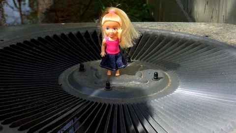 Audacious Doll On an Air Conditioner Stock Footage 105202547