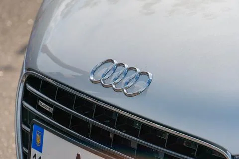 Audi car front view with interlinked rings logo at center of metal grille f.. Stock Photos