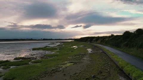 Audi car passes by camera on long coastal road, drone shot Stock Footage 246433490