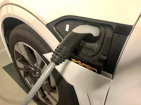 An Audi e-tron is being charged in public parking Stock Photos