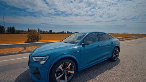 Audi e tron profile view. Audi e tron, a fully electric car on highway Stock Footage 160096774