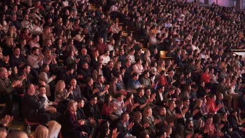 The audience applauded for a performance or presentation in the theater Stock Footage 138758096