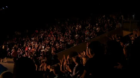 The audience applauds looking performance or presentation in the theater dark Stock Footage