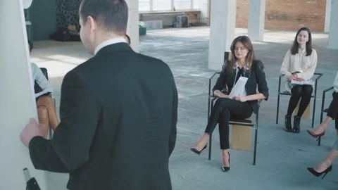 The audience asks questions to the young manager in a suit at the presentation Stock Footage 108034055