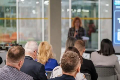 Audience attentively listens to presentation in modern conference room Stock Photos