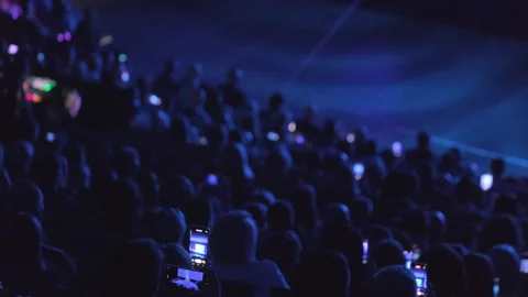 Audience capturing live stage performance with cellphones in dark theater Stock Footage 301692981