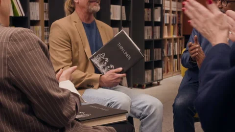 Audience Clapping, Listening to Man Talking About his Book During Presentation Stock Footage 329240560