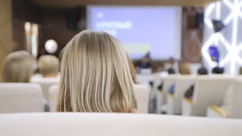 The audience at the conference is actively capturing memorable moments using Stock Footage 310825284