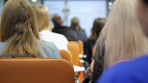The Audience Enthusiastically Listening to a Presentation Being Delivered at a Stock Footage 286977372