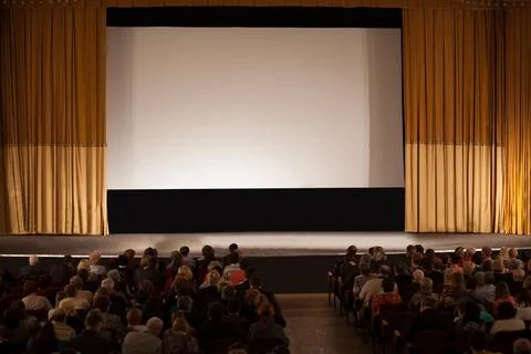 Audience in front of white cinema screen Audience seated in an auditorium ... Stock Photos