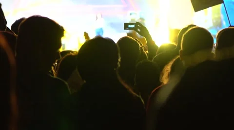 Audience of live show and bright stage flashes. Unrecognizable person shooting Stock Footage