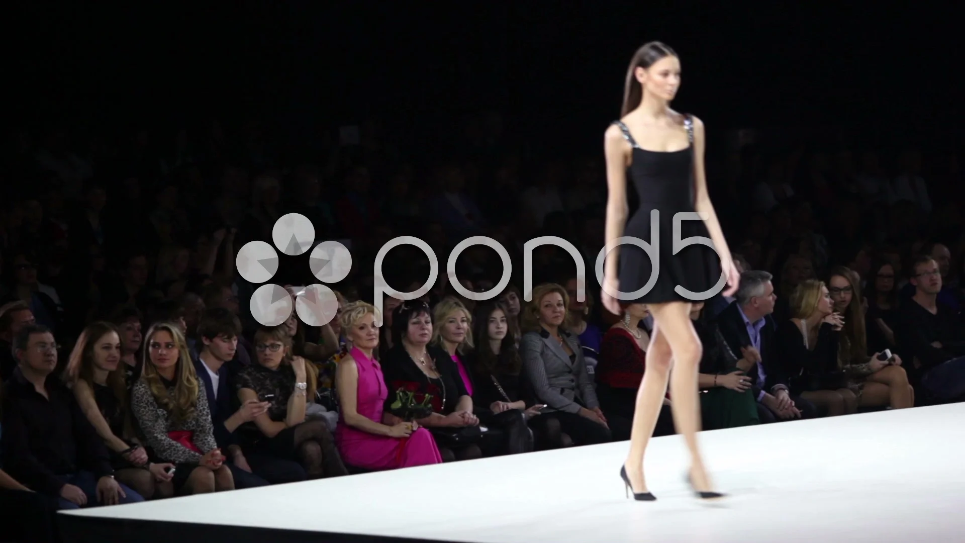 Audience look at model in short dress on... | Video | Pond5