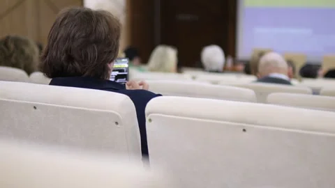 Audience member records speaker using smartphone Stock Footage 343592691