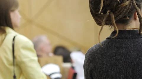 Audience members face forward at an event Stock Footage 342001325