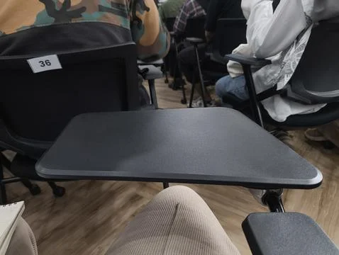 Audience sits in a classroom setting, focused and attentive Stockfoto's