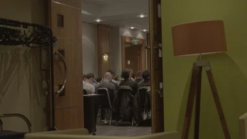 Audience sitting in seminar room viewed through doorway Stock Footage 342565949