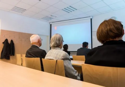 Audience at thesis presentation in a classroom. Stock Photos