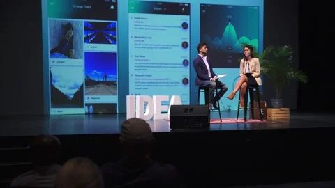 Audience using smart phones, watching app development speakers on stage Stock Footage 220368064