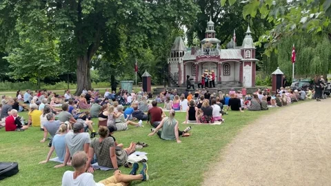 Audience watching H C Andersen show in the Fairy-tale Garden in Odense Centre Stock Footage 201998567