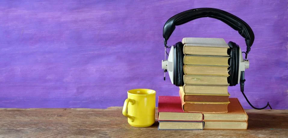 Audio book concept with stack of books and vintage headphones,literature Stock Photos