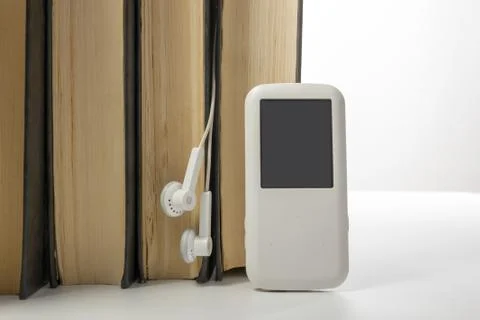 Audio book Stack of hardback books and electronic reader. Electronic library Stock Photos