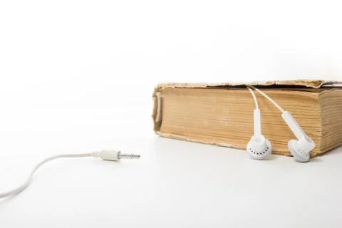 Audio book Stack of hardback books and electronic reader. Electronic library Stock-Fotos