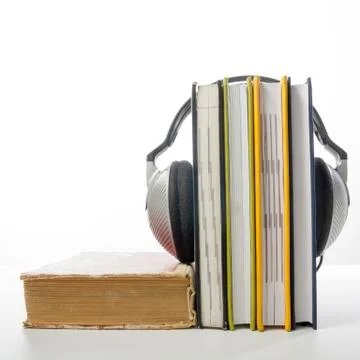Audio book Stack of hardback books and electronic reader. Electronic library Stock Photos