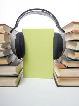 Audio book Stack of hardback books and electronic reader. Electronic library Stock Photos