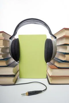Audio book Stack of hardback books and electronic reader. Electronic library Stock Photos
