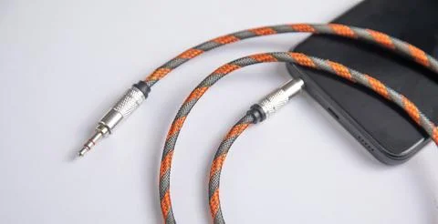 Audio cable connected in smartphone. Technology Stock Photos