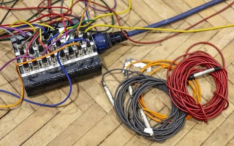 Audio cables and patch bay on a wooden floor in disarray. krst00275 Copyri... Stock Photos