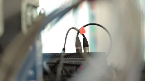 Audio cables with XLR and RCA connectors are plugged into the rear panel of a Stock Footage 341954342