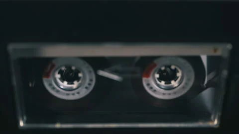 Audio Cassette is inserted into the Deck of the Audio Tape Recorder Playing and Stock Footage 104170340