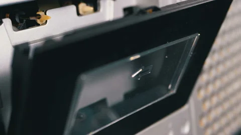 Audio Cassette is inserted into the Deck of the Audio Tape Recorder Playing and Stock Footage 104240301