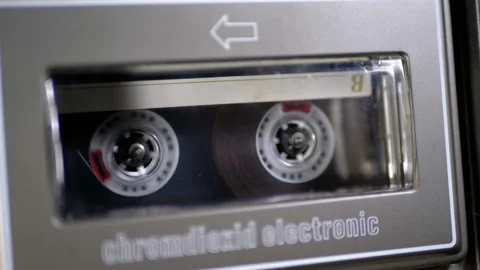 Audio Cassette is inserted into the Deck of the Audio Tape Recorder Playing and Stock Footage 104264514