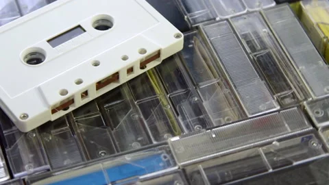 Audio cassette on a set of audio cassettes in cases. Turntable rotation Video stock 133522602