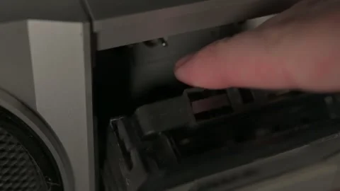 Audio cassette tape going into player Stock Footage 272482437