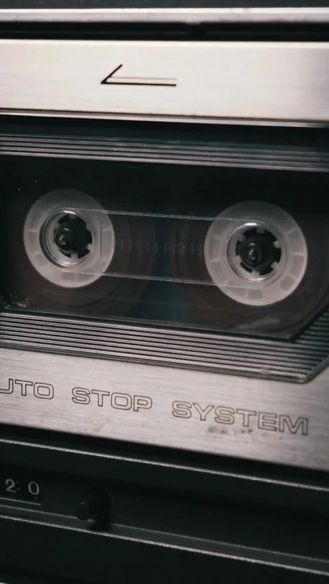 Audio Cassette Tape Rests Inside a Vintage Metallic Stereo Tape Deck System Video stock 334113373