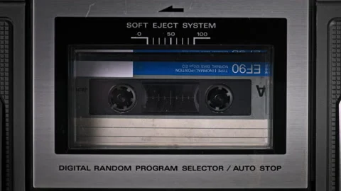 Audio Cassette Tape Rotates in Deck of an Old Tape Recorder Stock Footage 182642748