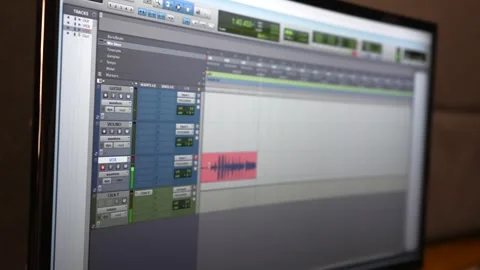 Audio editing software displayed on a computer monitor in a professional Stock Footage 284210615