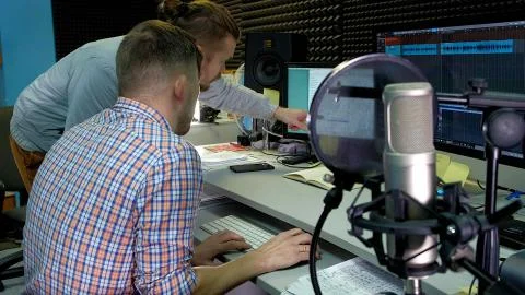 The audio editor is working on the audio track in the studio sound Stock Photos