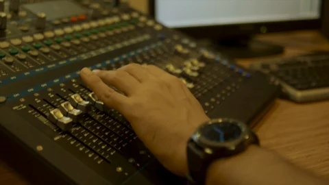 An Audio Engineer Adjusts A Mixer While A Band Play In the studio cabin Stock Footage 109461155