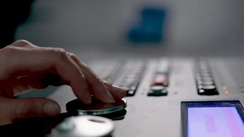 Audio Engineer Hand Adjusting Dial on Mixing Console Stock Footage 340243078