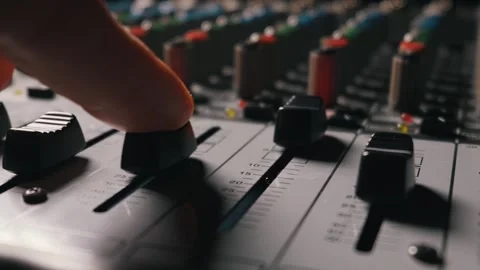 Audio Engineer Hand Adjusting a Fader on a Professional Sound Mixing Console Stock Footage 334737612